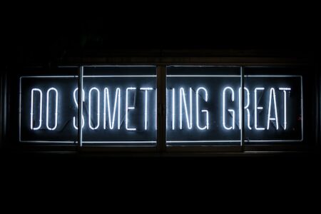 a neon sign saying "Do Something Great"
