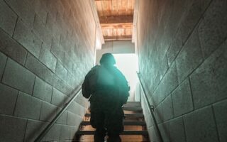 man in black jacket walking on staircase
