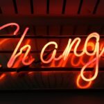 a neon sign that spells "Change"
