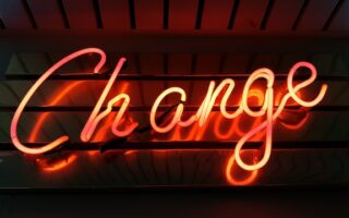 a neon sign that spells "Change"