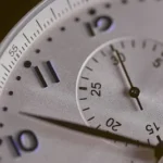 a close up of a silver watch face