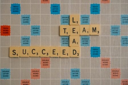 scrabble that says "Lead team succceed"